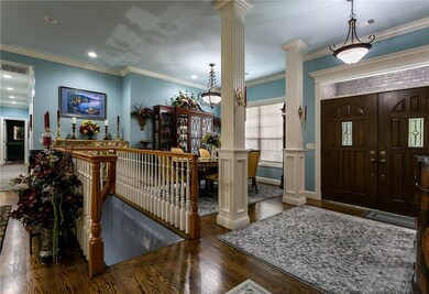 Double doors welcome visitors to the columned entry way