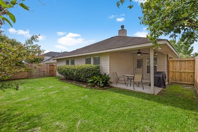 Decent backyard space with covered patio area perfect for outdoor grilling and dining.