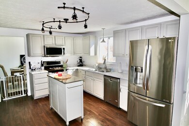 Beautiful kitchen with light gray cabinets with gorgeous faux white marble laminate countertops which were installed less than 2 years ago. All kitchen appliances are 2015 LG products and stay with the home.