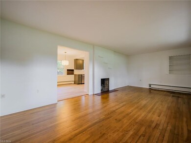 Empty room featuring a baseboard heating unit, bui