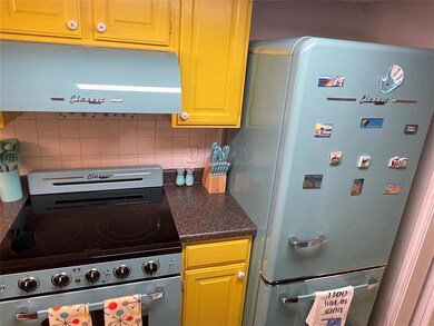 Kitchen featuring refrigerator, backsplash, and st