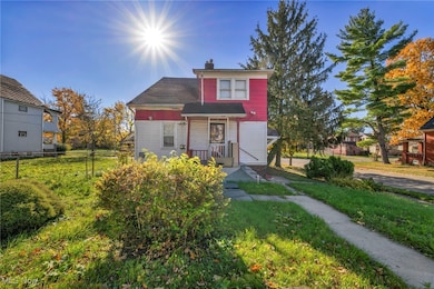 View of front facade with a chimney and covered porch