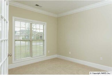Study with carpet, crown moulding and french doors for when you need some peace and quiet.