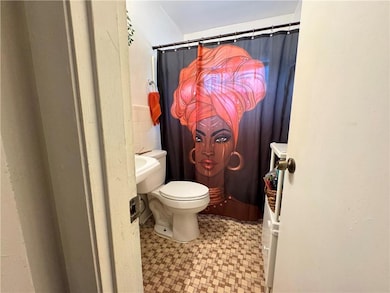 Bathroom with tile walls, toilet, and tile pattern