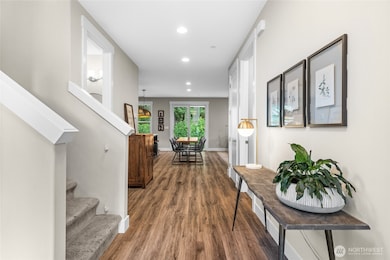 Luxury laminate flooring unifies the living spaces, creating a sophisticated sense of continuity throughout.