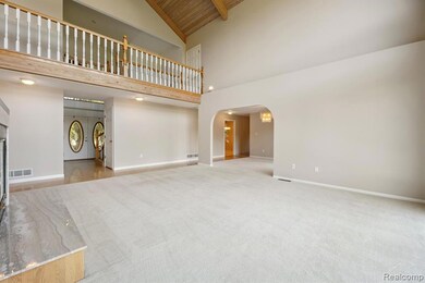 Unfurnished living room with light carpet, arched walkways, high vaulted ceiling, and a wooden ceiling with exposed beams