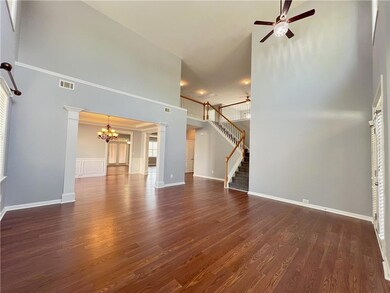 Unfurnished living room featuring dark wood-type f