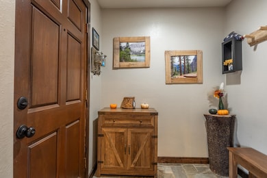 Entry featuring a textured wall and stone finish flooring