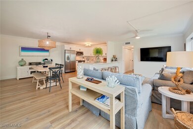 Living room featuring crown molding and light wood-type flooring