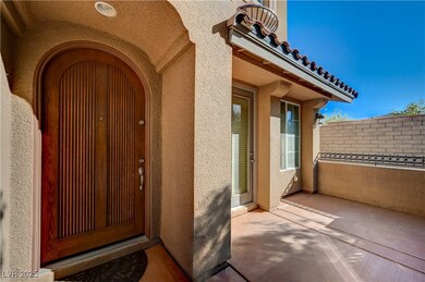 View of exterior entry featuring a tiled roof and