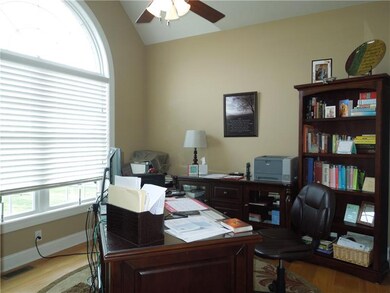 Den has hardwood floors as well as big picture win
