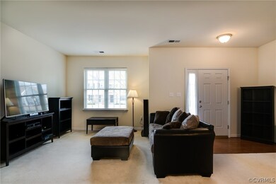Foyer area with wood floors and spacious family ro