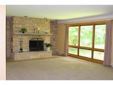 Large living room with wood burning fireplace made