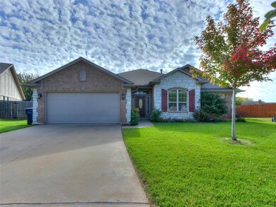 Ranch-style home featuring a front yard and a gara