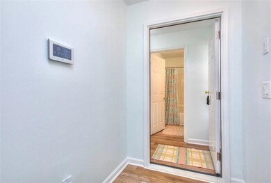 Hall featuring light wood-style flooring and baseboards