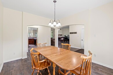 Dining area featuring arched walkways, dark wood-