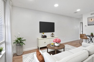 Living room featuring light wood-style floors, re