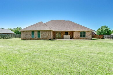 Rear view of house featuring a patio area and a ya