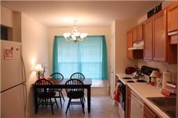 Kitchen has an abundance of cabinet space as well as a closet pantry. Refrigerator can remain. Table set can remain. Sparkling clean!