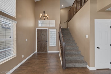 Foyer featuring a chandelier, dark wood-type tile