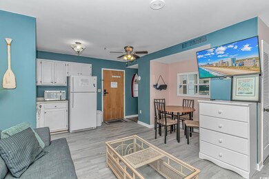 Living area with light wood-style flooring, a ceiling fan, and baseboards