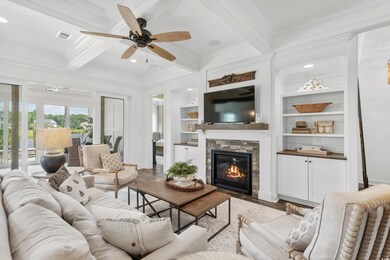 Living room featuring ceiling fan, beam ceiling, l