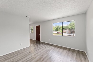 Empty room featuring wood finished floors, a text