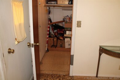 Storm cellar under entry coat closet floor.