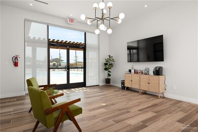 Living area with wood tiled floors, recessed lighting, and a chandelier