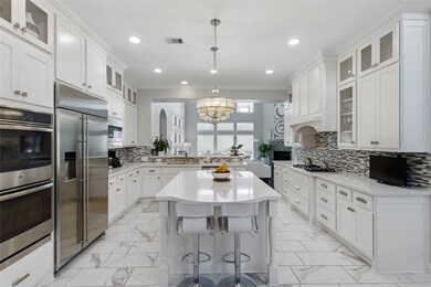 This kitchen is by far any chef’s dream! This spacious kitchen features white stained wood cabinets, quartz countertops, SS appliances, custom tile backsplash, recessed lighting, extended counter space, separate kitchen island and a walk-in pantry all overlooking your huge family room.