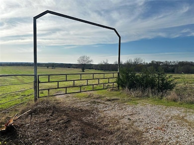 View of yard featuring a rural view and fence