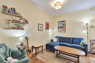 Living room featuring crown molding and wood fini