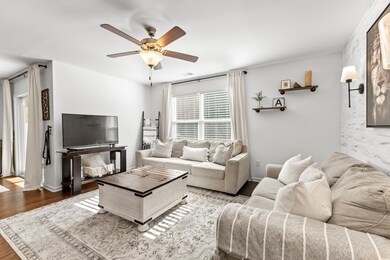 Living room with hardwood / wood-style flooring an