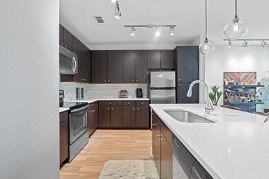 Kitchen featuring light wood finished floors, sta