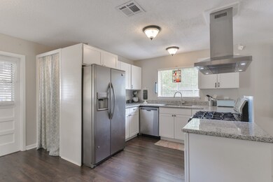 Updated kitchen features clean lines, ample countertop space, and welcome interaction with guests.