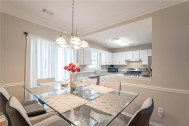 Dining room featuring a chandelier and crown molding
