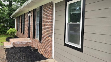 View of side of home featuring brick siding