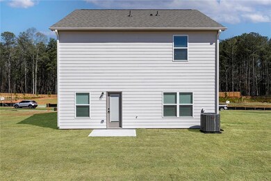 Back of property featuring a yard and roof with shingles