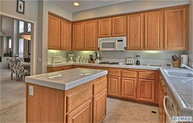 Immaculate kitchen features center island, pantry,