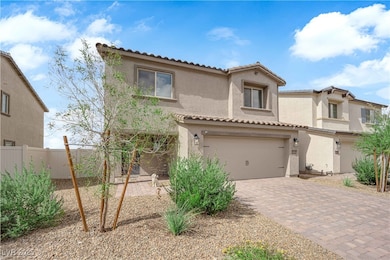 home with stucco siding, a tile roof, decorative driveway, and a garage