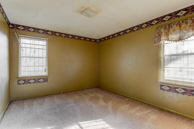 Carpeted empty room featuring a wealth of natural 