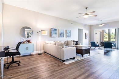 Living room with ceiling fan and hardwood / wood-s