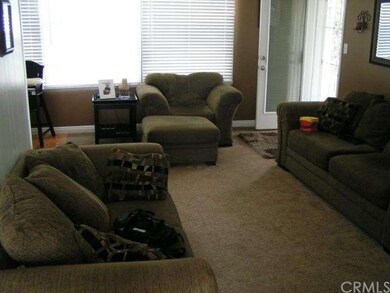Living room has wall to wall carpet. Entrance to d