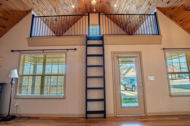 Doorway featuring a towering ceiling, plenty of na
