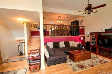 Spacious Living Area features Rich Hardwood Floori