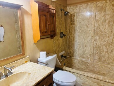 Bathroom with vanity and bathtub / shower combination