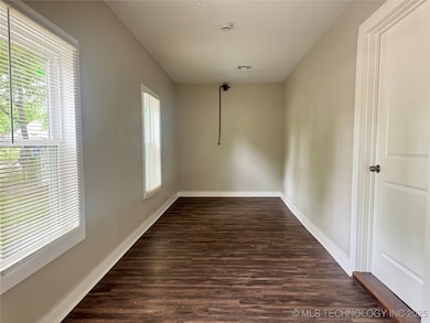 Spare room featuring plenty of natural light, dark