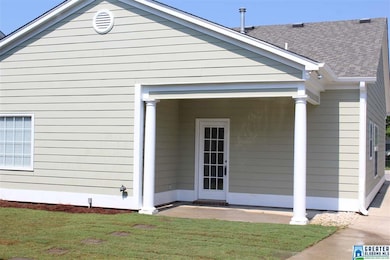 COVERED PORCH AREA ON REAR OF HOME WITH NEW GRASS 