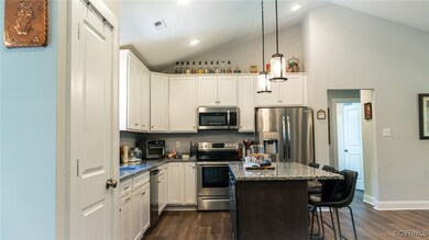 Kitchen featuring a kitchen breakfast bar, dark wo