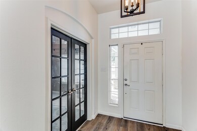 French Doors off the entryway lead to office